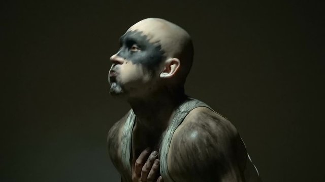 Bald man vomiting black goo