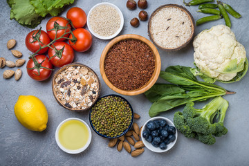 Selection of  food for health, cereals, nuts, fruits, vegetables and greens. Flat lay