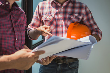 architect and engineer inspect housing estate building to success construction plan before send...