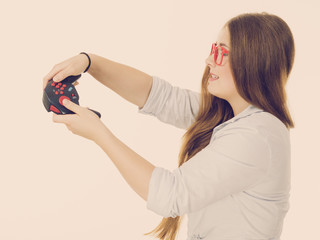 Profile view of woman playing video games
