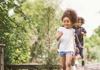 Cute little girl playing outdoor. kid and friend happy play at park.