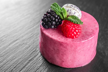 Tasty berry mousse cake on dark background