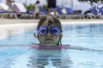 Pretty little girl in swimming pool