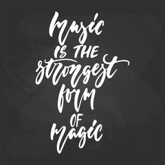 Fototapeta na wymiar Music is the strongest form of magic - hand drawn Musical lettering phrase isolated on the black chalkboard background. Fun brush chalk vector quote for banners, poster design, photo overlays.