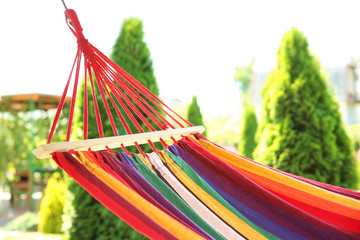 Colorful hammock outdoors on sunny summer day