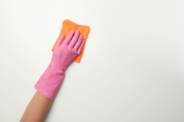 Woman holding rag on white background. Cleaning service
