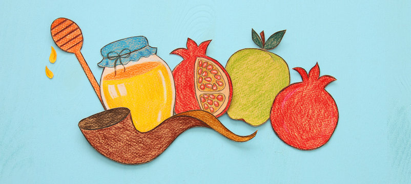 Rosh hashanah (jewish New Year holiday) concept. Traditional symbols shapes cut from paper and painted.