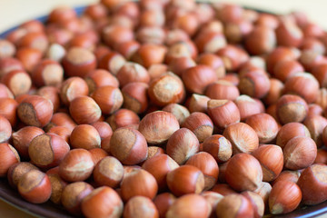 A lot of hazelnuts in a big plate.