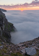 Sunset in the fog on the mountains of Soroya Island, Norway