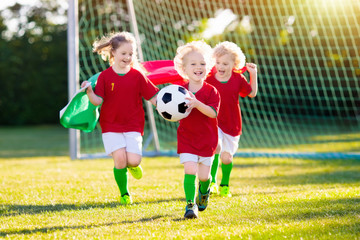 Portugal football fan kids. Children play soccer.