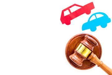 Car accident lawsuit concept. Two collided cars near judge gavel on white background top view copy...