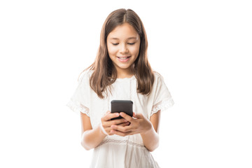 Fototapeta premium Young latin girl in white blouse using smartphone