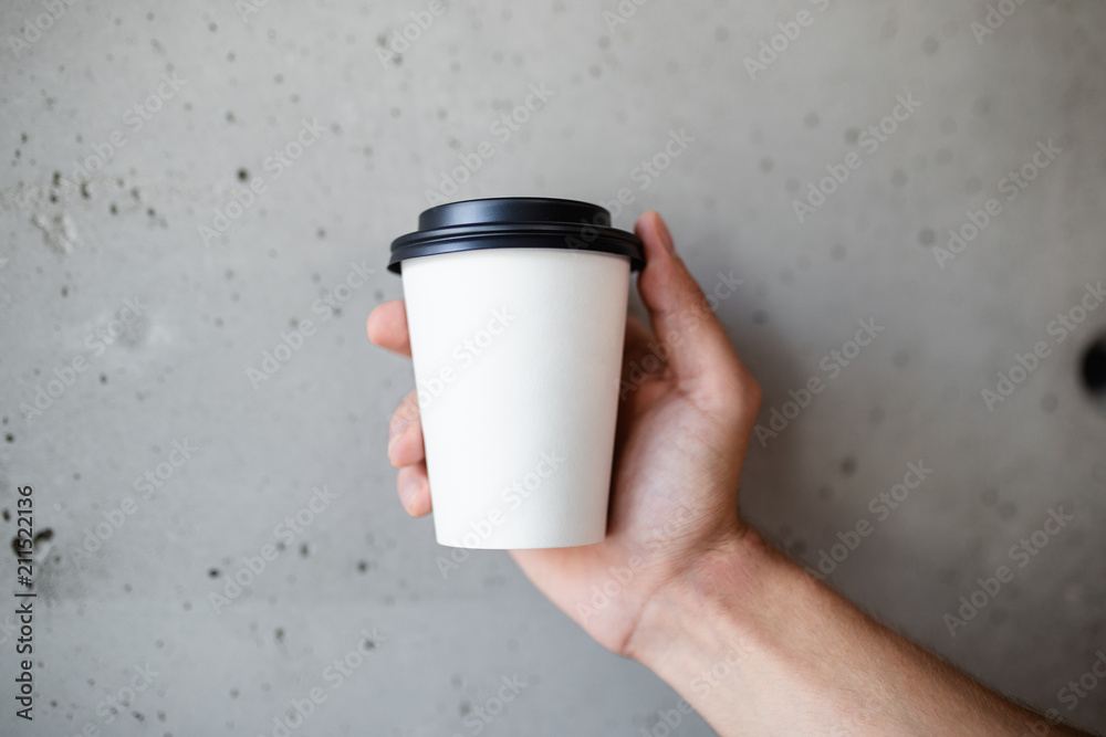 Canvas Prints barista holding cup of coffee to go.