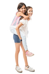 Fototapeta premium Young girl carrying sister giving piggyback ride