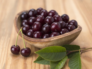 cherry berries on a wooden table. 