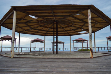 observation deck with canopies. The territory is abandoned and is not used for its intended purpose. The tree is partially destroyed and the roof is dangerous