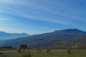 view of the mountains from the valley. The Crimean mountains are shrouded in a bluish haze. 