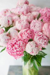 Beautiful bouquet of pink peonies . Floral composition, daylight. Wallpaper. Lovely flowers in glass vase.