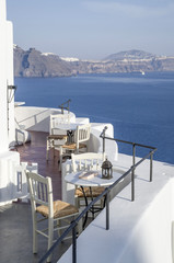 View of empty outdoor restaurant on the seashore in Oia, Santori