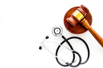 Medical law, health law concept. Gavel and stethoscope on white backgound top view copy space