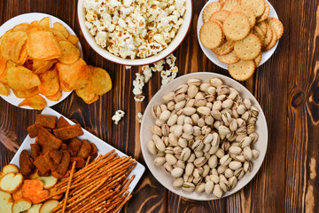 Snacks on a wooden background. Space for text or design.