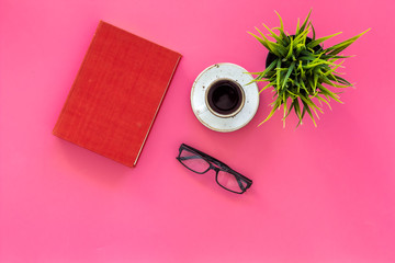 Reading for study and work. Self-education concept. business literature. Books with empty cover near glasses, coffe, plant on pink desk top view copy space