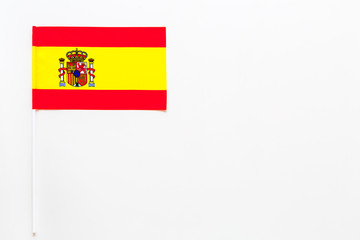 Spanish flag concept. Small flag on white background top view copy space