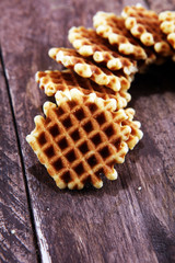 Traditional belgian waffles on wooden background