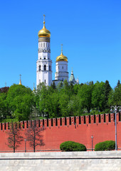 Cathedrals  of Moscow Kremlin behind  red kremlin wall