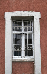 Fototapeta na wymiar STANBUL - Sirkeci train station white wooden window with old red wall
