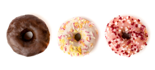 Three different doughnuts, with chocolate and candy powder on a white. The view from the top.