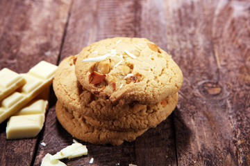 stack of macadamia nut and white chocolate cookies on table with chocolate chip