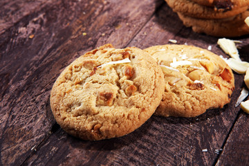 stack of macadamia nut and white chocolate cookies on table with chocolate chip