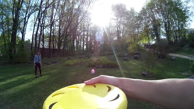 Beautiful girl throwing frisbee in a park POV 1
