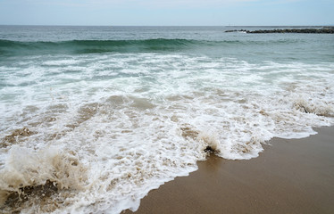 close up on sea wave and beach
