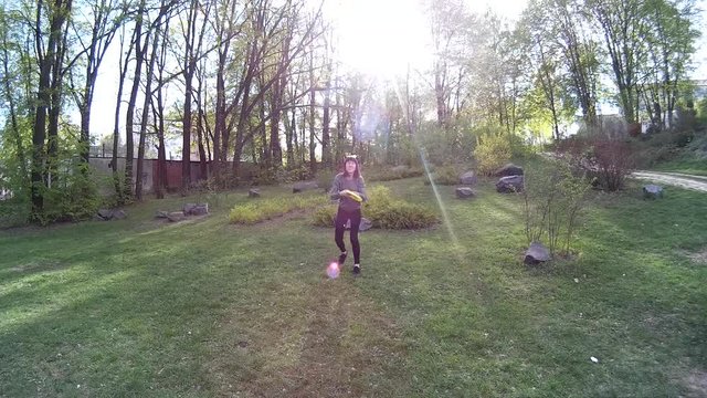 Beautiful girl throwing frisbee in a park POV 2