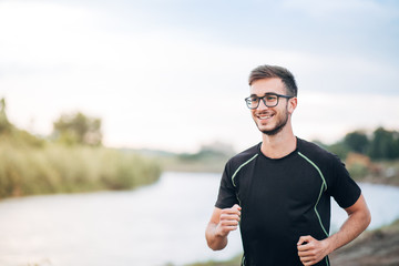 Young Man Running By the River