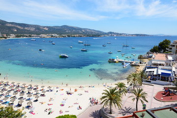 The tourists enjoiying their vacation on the beach, Mallorca, Spain