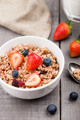 Bowl of healthy cereal granola with strawberries