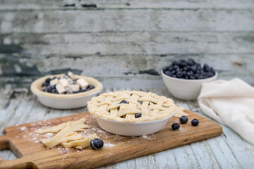 Homemade small individual blueberry pies with fresh summer blueberries
