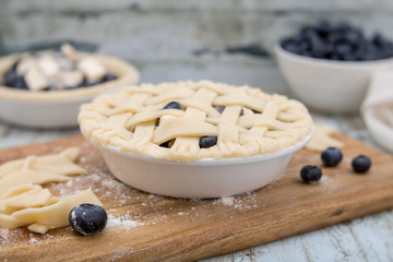 Homemade small individual blueberry pies with fresh summer blueberries