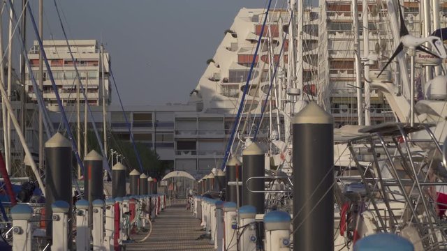 View over a jetty with many boats and facilities in the marina of La Grande Motte, France, Mediterranean