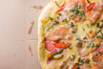 Italian pizza on wooden boards, pizza with bacon, dried tomatoes and Parmesan cheese, Italian cuisine, appetizing dish with meat and cheese, copy space