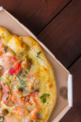 Italian pizza on wooden boards, pizza with bacon, dried tomatoes and Parmesan cheese, Italian cuisine, appetizing dish with meat and cheese, copy space