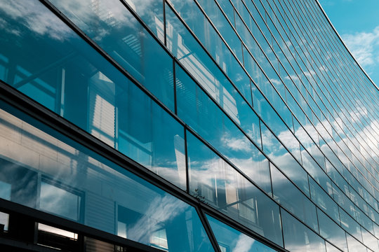glass facade of modern office building and blue sky -