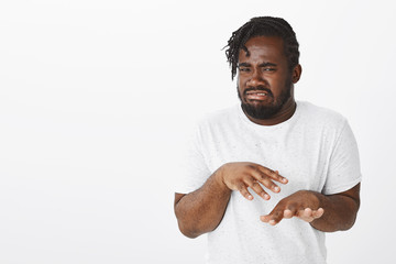 When you touch food in sink. Portrait of disgusted funny dark-skinned guy in white t-shirt, shaking...