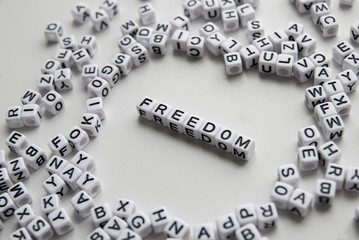 freedom word written on cubes on white background. Creative text for your business. Chaotic letters design