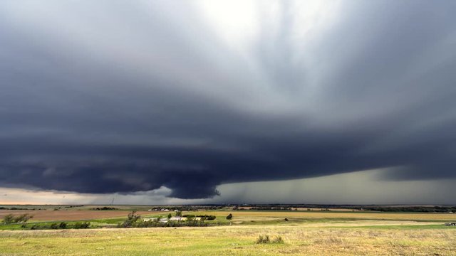 Large, powerful tornadic supercell storm moving over a small town in Oklahoma sets the stage for the formation of tornados across Tornado Alley. 
