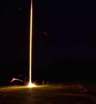 A rocket firework shooting off.