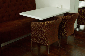 brown armchairs and white table. dining room kitchen interior.